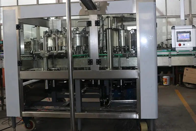Automated bottle filling machine on a factory floor
